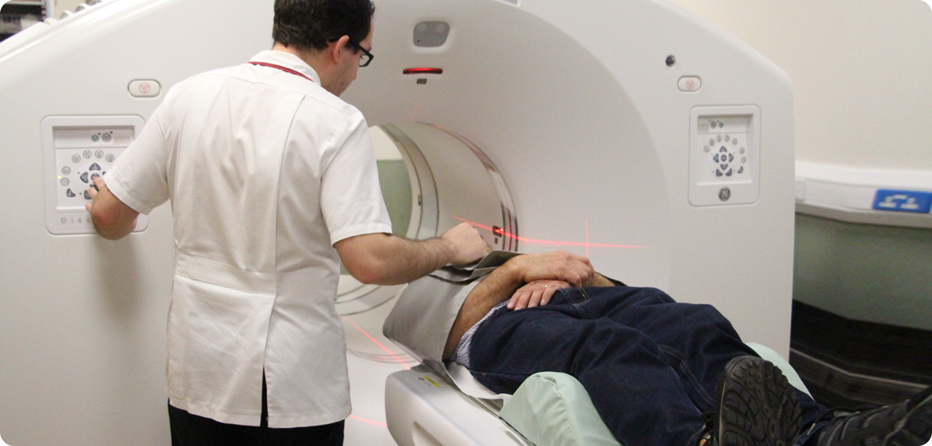 Image of a doctor putting a patient into an MRI machine