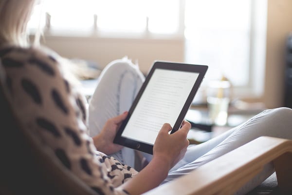 woman-sitting-on-chair-using-black-ipad-196649 – Copy